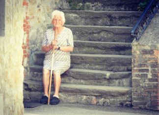 Old lady sitting on stairs