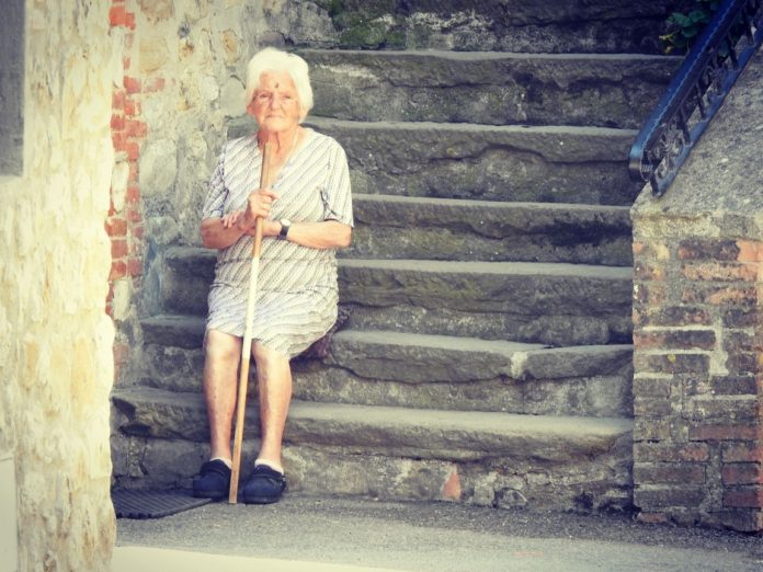 Old lady sitting on stairs