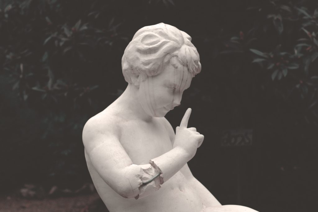 Statue showing with finger that something is wrong