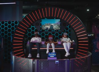 Three people siting in dome playing virtual reality game with virtual reality headset