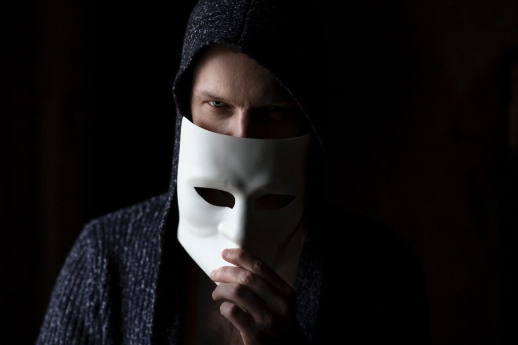 Person with a mask on black background