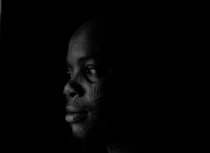 Person looking dreamy thinking with black background