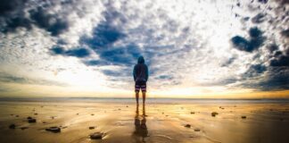 One person alone standing at the beach