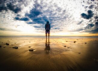 One person alone standing at the beach