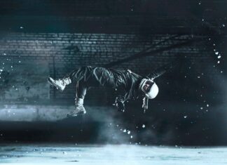 Person floating without gravity with helmet on black background