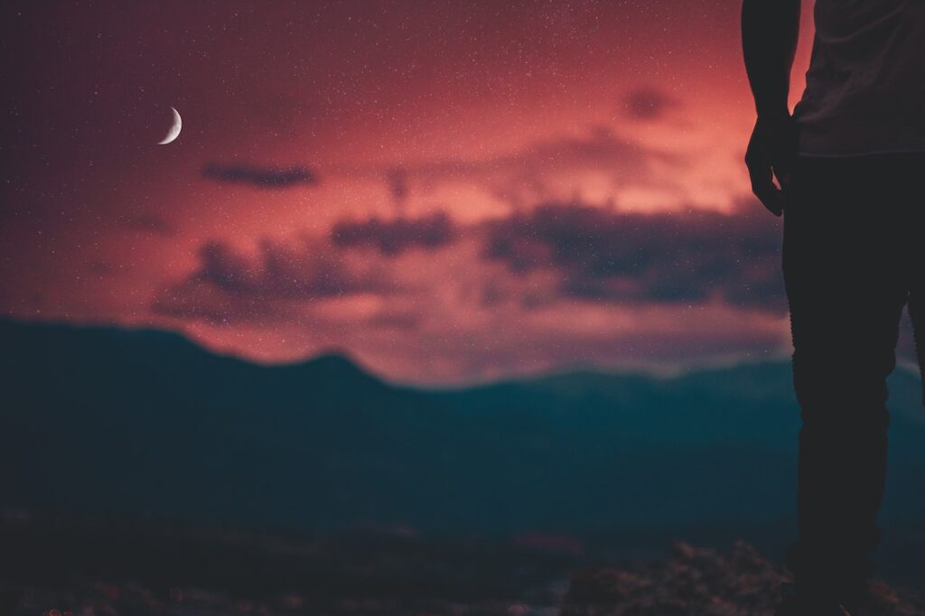 Night picture of the sky and moon with person standing