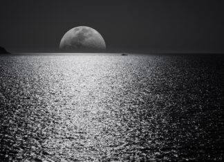 White and Black Moon With Black Skies and Body of Water Photography during Night Time