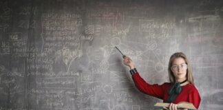 Female person showing on blackboard representing intelligent species