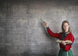 Female person showing on blackboard representing intelligent species