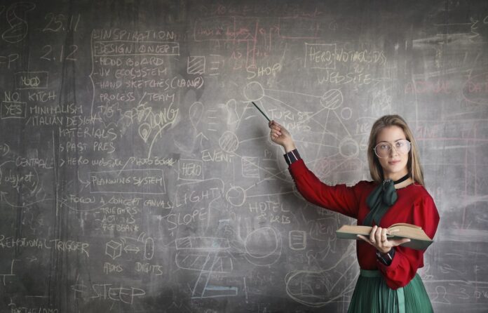 Female person showing on blackboard representing intelligent species