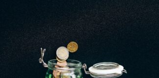 Coins in a jar with black background