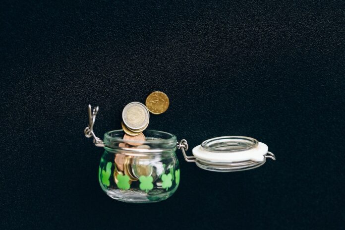 Coins in a jar with black background