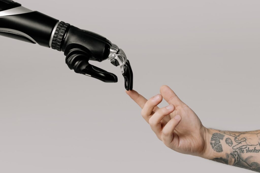 Human hand touching robot hand representing love