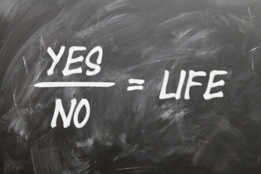 Yes No written on table equating Life - Philosophy