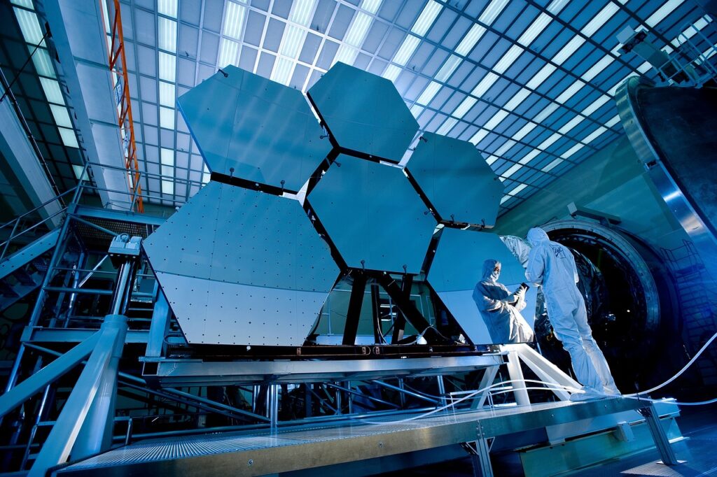 Two people standing in front of telescopic mirror