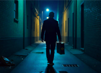 Person in dark alley carying briefcase with Bitcoin sign