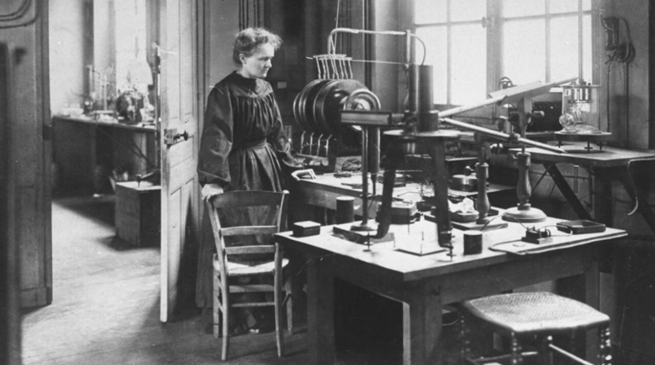 Marie Curie in a lab black and white photo